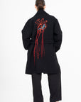 OSCAR MENDOZA Long wool coat, large embroidered heart on the back